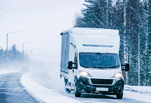 Cargo Box van driving on a snowy road
